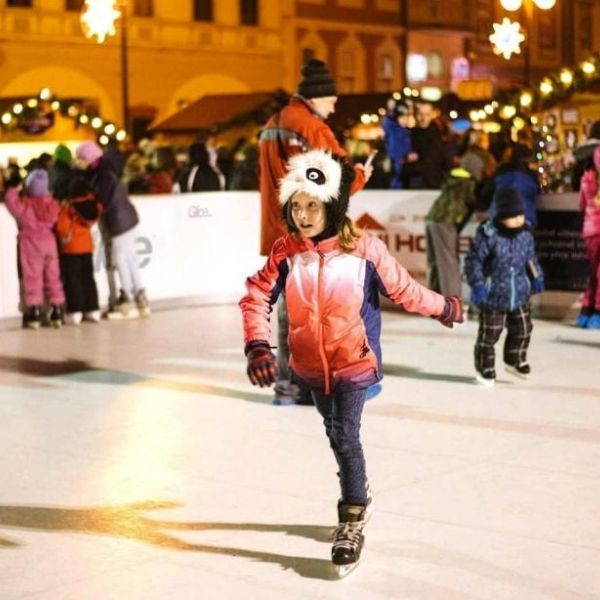 girl skating on artificial christmas rink
