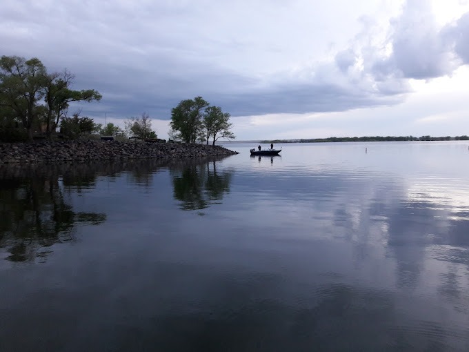 a small boat on a lake at twilight